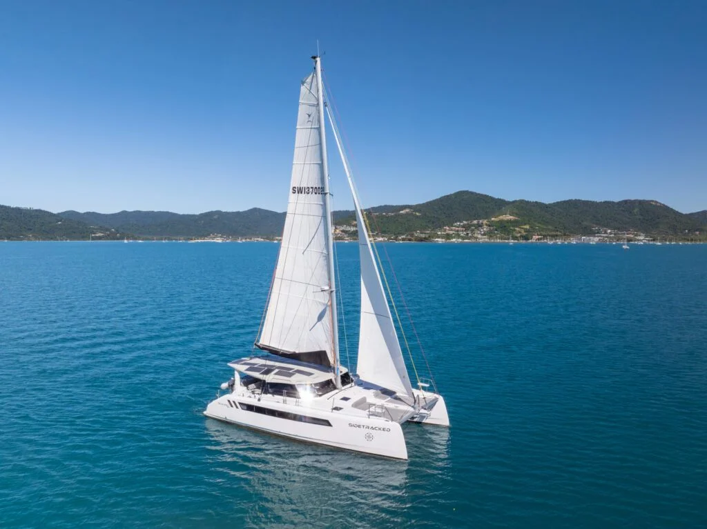Sidetracked Seawind 1370 sailing catamaran under sail in the Whitsundays